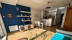 A compact living space with a dining area, kitchenette, and a small bathroom. - CARNAC - Apartment 2 rooms - 4/5 persons - Terrace Sea View (CARNAC)