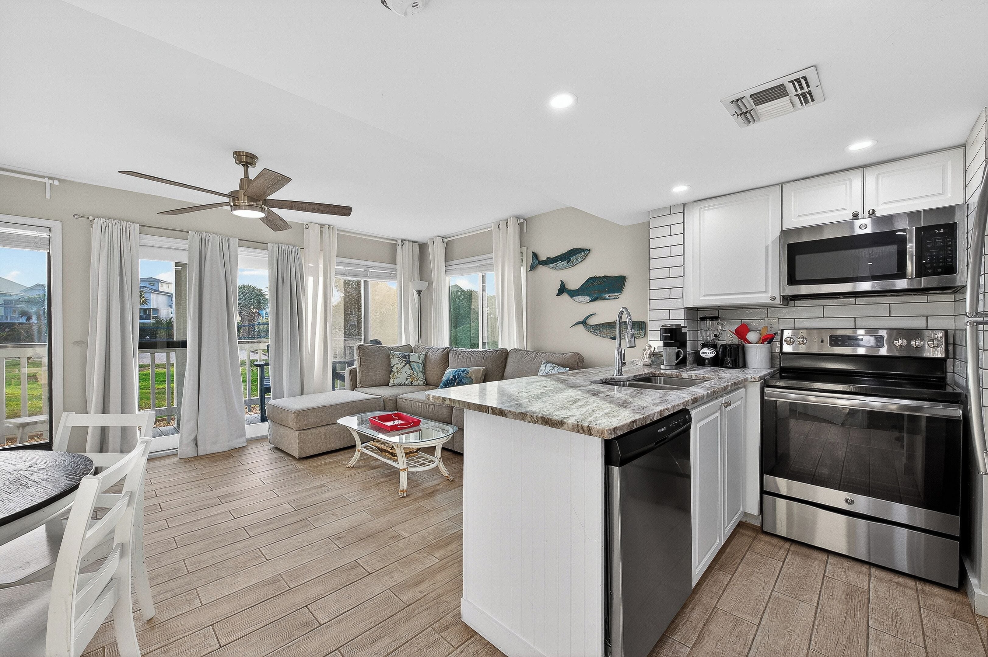 A modern kitchen with a built-in microwave, oven, and dishwasher.