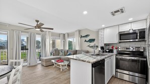 A modern kitchen with a built-in microwave, oven, and dishwasher. - Gulf Shores Plantation-West 1154 (Gulf Shores)