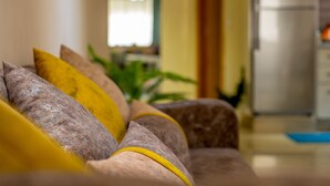 A sofa with multiple cushions in a well-lit indoor space. - Modern & Large Studio in Casablanca - Bd Anfa (Casablanca)