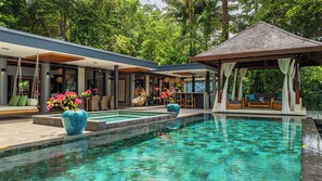 A modern resort with a clear pool, outdoor seating, and lush greenery. - Casa Selva Ocean View Luxury Home- 4 Bedroom (Puntarenas Province)