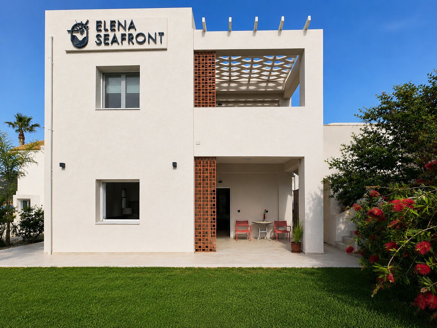 A modern two-story building with a sign reading 'ELENA SEAFRONT'.