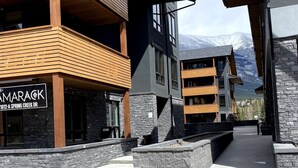 A modern building with a sign reading "AMARAKK 1012-A SPRING CREEK DR." - Luxury, Spacious, New, Entire Condo Suite, Scenery Year-round Mountain Getaway (Canmore)
