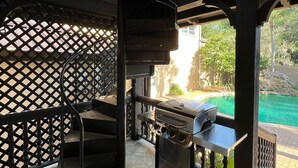A covered outdoor area with a grill and a pool. - Welcome to The Urban Mansion in Midtown Tallahassee (Tallahassee)