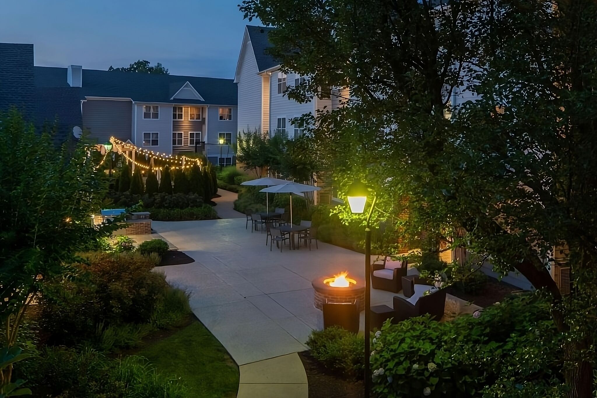 Unwind under twinkling lights by the glowing fire pit.