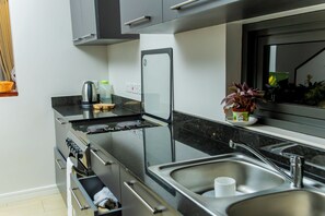 Basic Apartment, Patio, City View | Private kitchen | Fridge, microwave - Greenleaf Residence (Kampala)