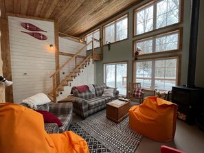 A cozy living room with a couch, a coffee table, and a fireplace.