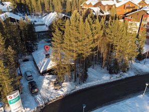 A ski resort with a marked location, a parking area, and a sign for a coffee house.