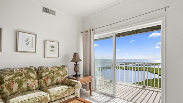 A balcony with a view of a body of water and greenery. - Maresol 502 by Seaside Vacations & Sales (Ocean City)