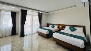 A hotel room with two beds, a large window with curtains, a marble floor, and a ceiling-mounted air conditioning unit. - Sunrise Motel (Tuan Chau)
