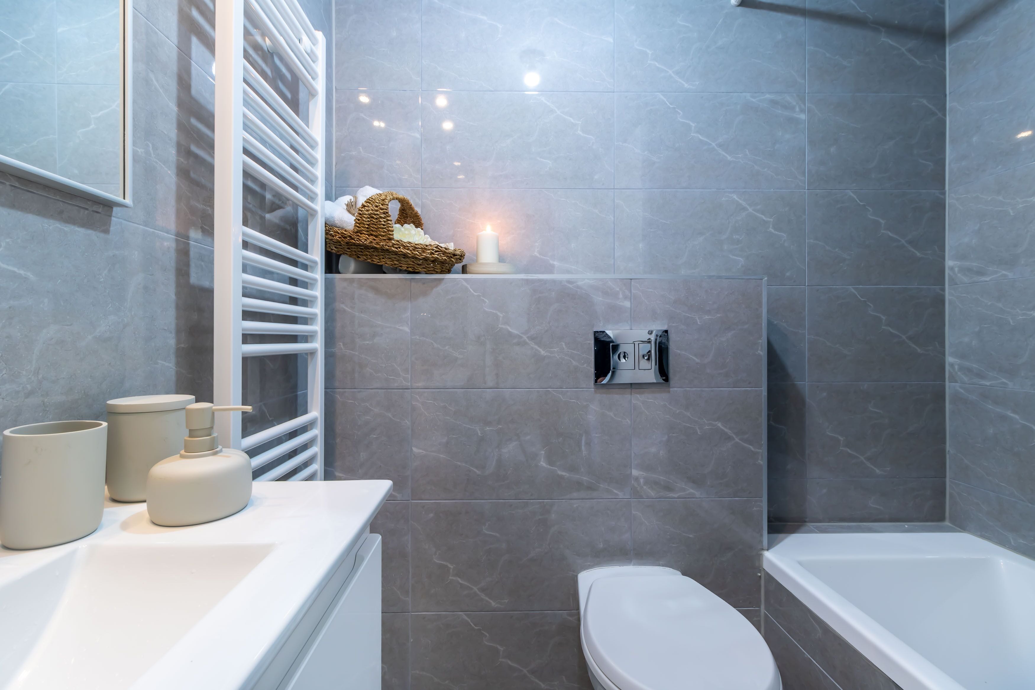A modern bathroom with a shower, toilet, and sink area.