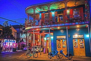 A multi-story building with balconies, a ground-level entrance, and a sign reading "601".