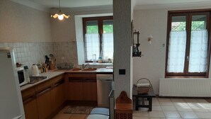 A kitchen with a microwave, sink, and cabinets.