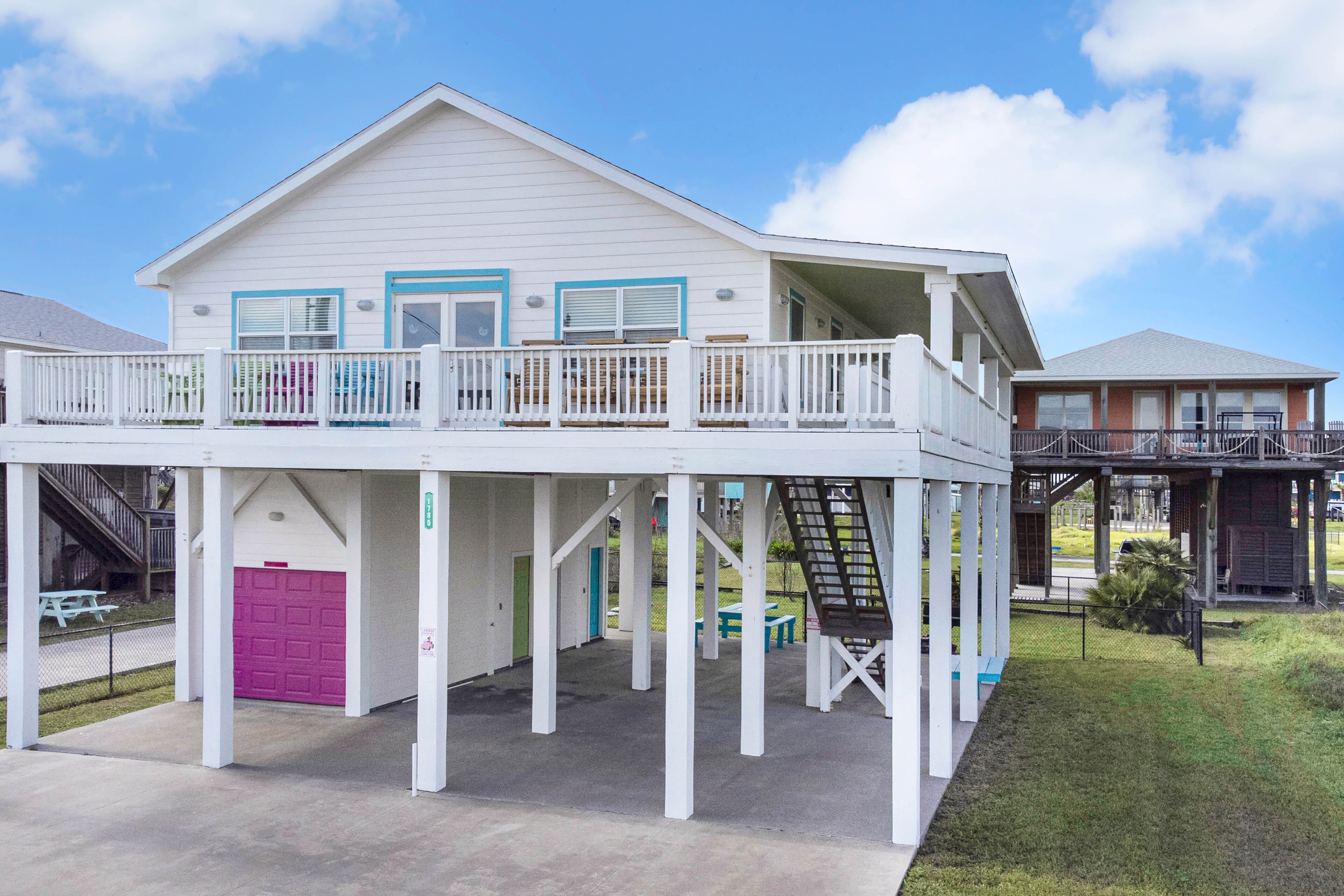 Colorful beachfront stay with scenic balconies, gas grill, W/D, & AC - dogs ok