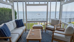 A covered outdoor seating area with a view of the water. - Cozy Waterfront Home In Portsmouth (Portsmouth)