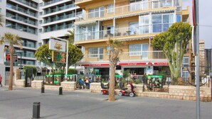 A multi-story hotel with balconies, outdoor seating, and a pedestrian area. - Penthouse Ancla 562 Levante Beach (Benidorm)