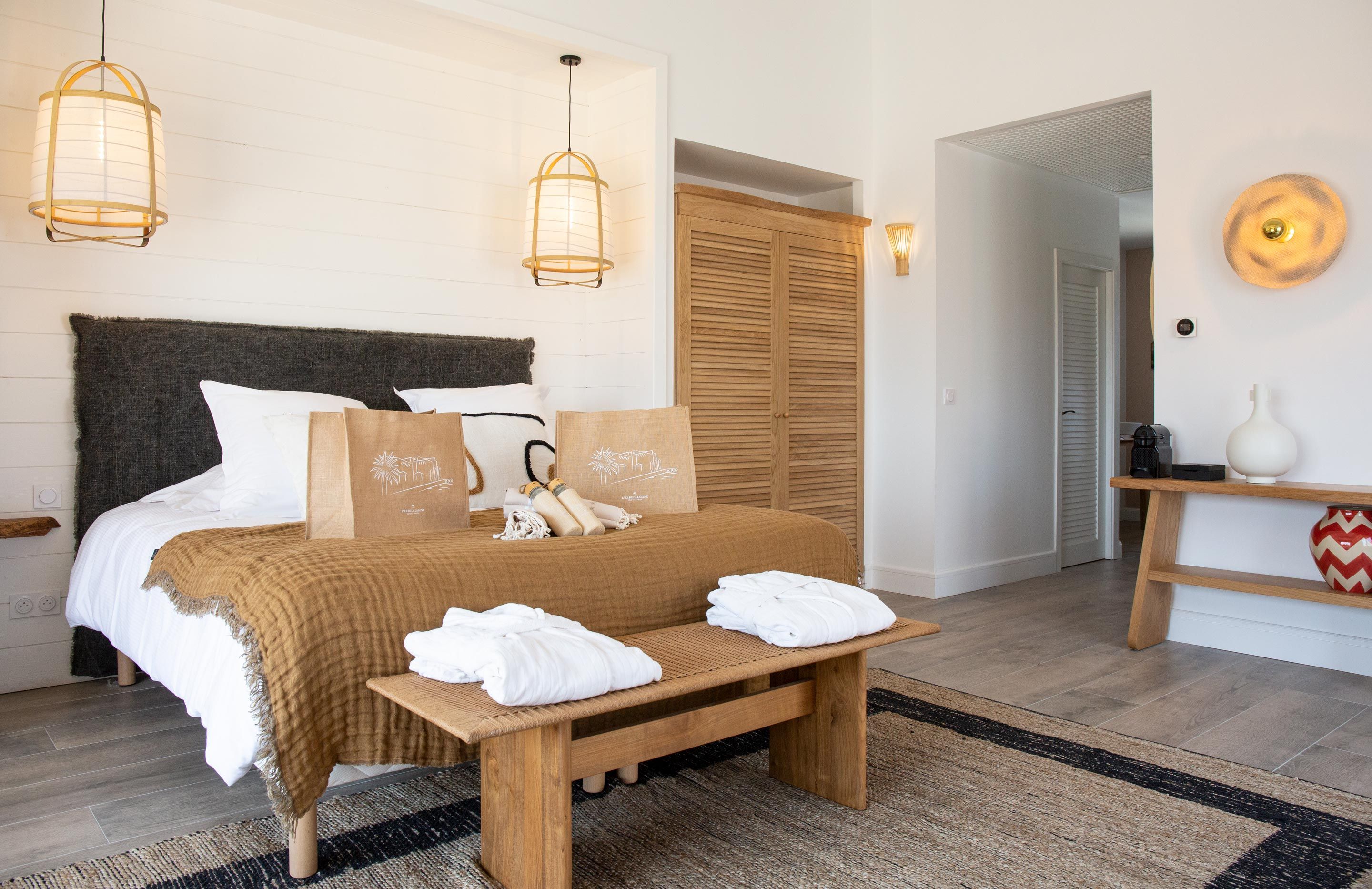 A neatly arranged bedroom with a bed, bedside tables, and a bench.