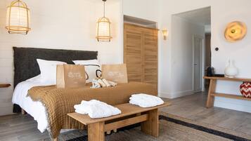 A neatly arranged bedroom with a bed, bedside tables, and a bench.