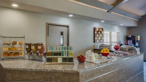 A breakfast bar with various food items and a coffee machine. - Residence Inn By Marriott South Bend (South Bend)