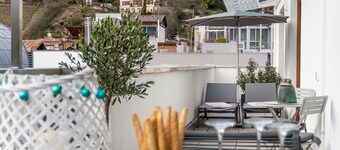 Merano center penthouse with terrace, garage, bike room and infrared sauna.