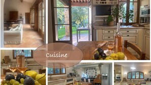 Una cocina con comedor, chimenea de piedra y vistas al exterior.