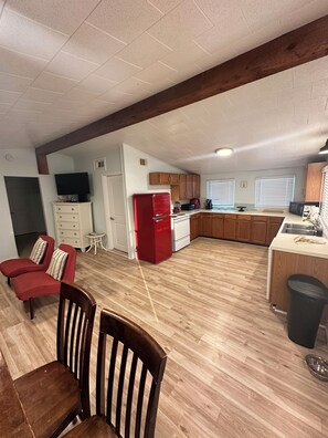 Relax in this inviting living area with a dining table, sofa, and TV.