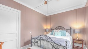 A bedroom with a bed, bench, nightstands, and a ceiling fan. - Close to Hospital and Downtown, Eastside Bungalow, Dogs Welcome + Fee (Florence)
