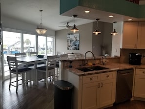 Enjoy meals in this kitchen with a central island, sink, and dining area.