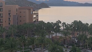 A coastal hotel with multiple floors, palm trees in the foreground, and mountains in the background. - Luxury Suite, The Islands of Loreto - stunning natural beauty in Mexico (Loreto)