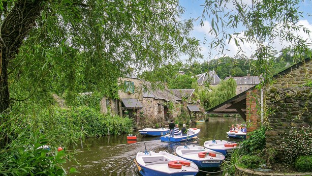A canal with boats docked along the side, surrounded by greenery and stone buildings. - Amazing home in Quemperven with WiFi (Quemperven)
