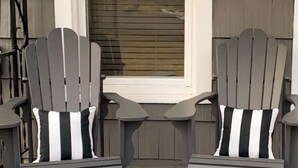 Two Adirondack chairs with black and white striped cushions, positioned in front of a window with wooden blinds. - Walk to downtown and only a block from the river! (Bend)