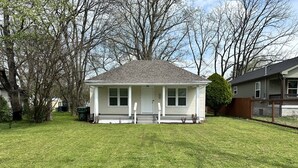A single-story house with a front porch, a well-maintained lawn, and a wooden fence. - Hickory Landing (Nashville)