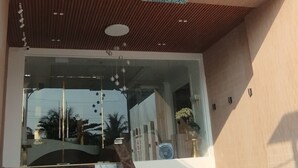 The exterior of the Green Men Hotel with a modern design, featuring a prominent staircase leading to the entrance. - PHUC THANG HOTEL (Phu Quoc)