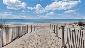 A sandy beach path leading to the ocean with a clear sky. - Sunrise & Sunset Oceanfront Condo (Ocean CIty)