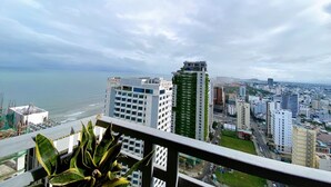 A cityscape with a view of the ocean, featuring modern buildings and a hotel named 'Rosamita'. - Muong Thanh Apartment Luxury 03 bedroom (Da Nang)