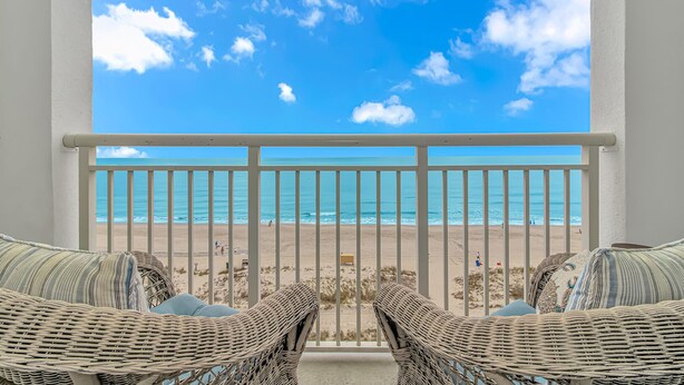 A balcony with wicker chairs and a view of the beach. - Amazing OCEAN FRONT Views!  Newly Renovated!   Walking Distance to All  Myrtle.  (Myrtle Beach)