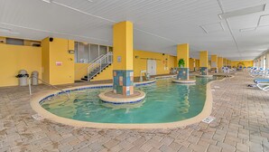 An indoor swimming pool with multiple lanes, yellow walls, and a staircase leading to an upper level. - Amazing OCEAN FRONT Views!  Newly Renovated!   Walking Distance to All  Myrtle.  (Myrtle Beach)
