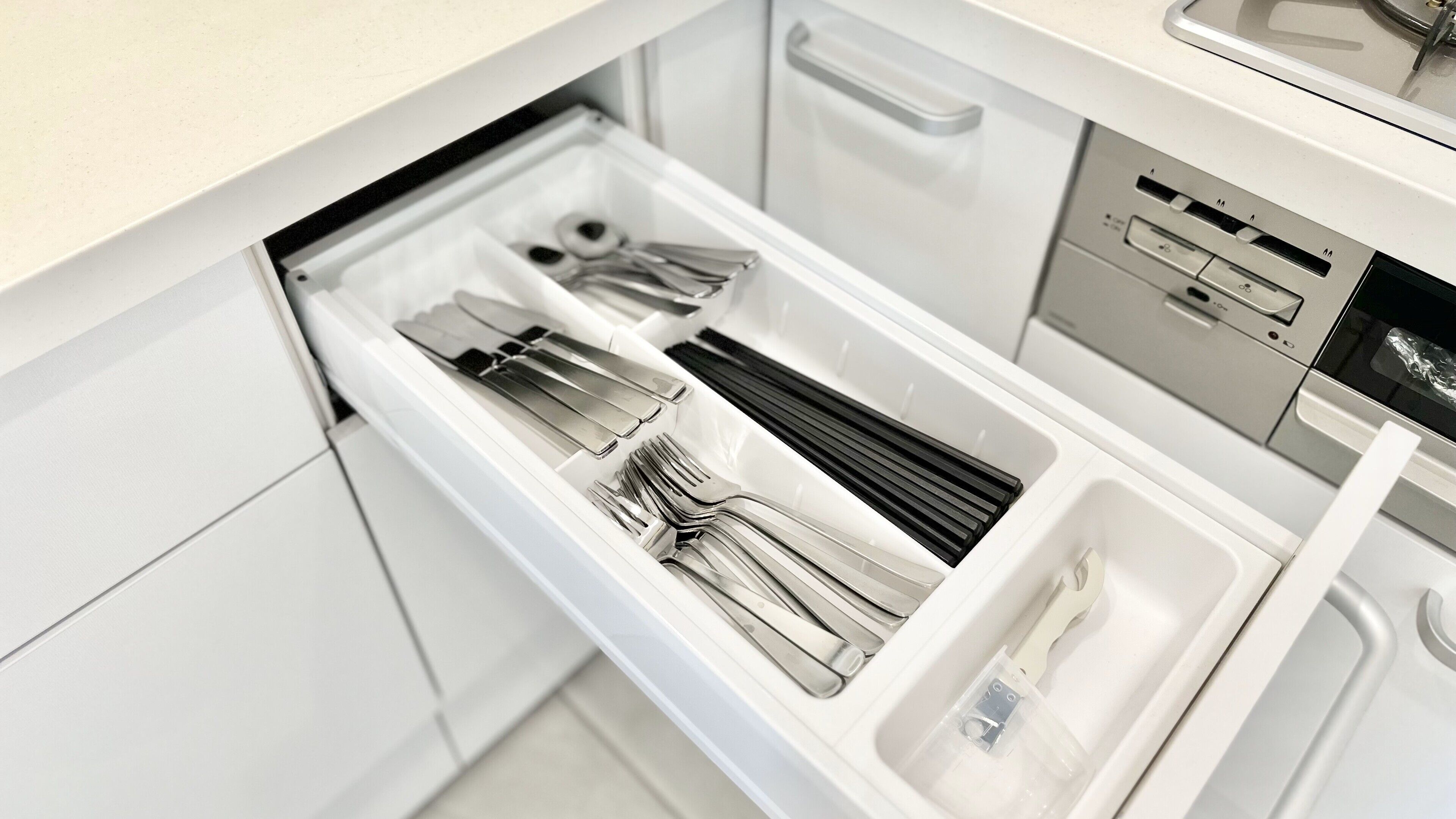 A kitchen drawer with utensils and appliances.