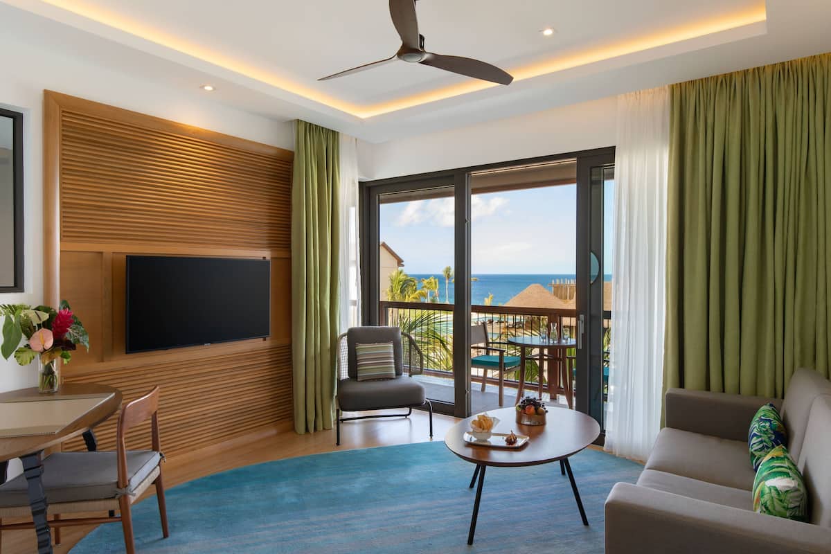 Enjoy a panoramic ocean view from the comfort of this room, featuring a flat-screen TV, seating area, and outdoor space.