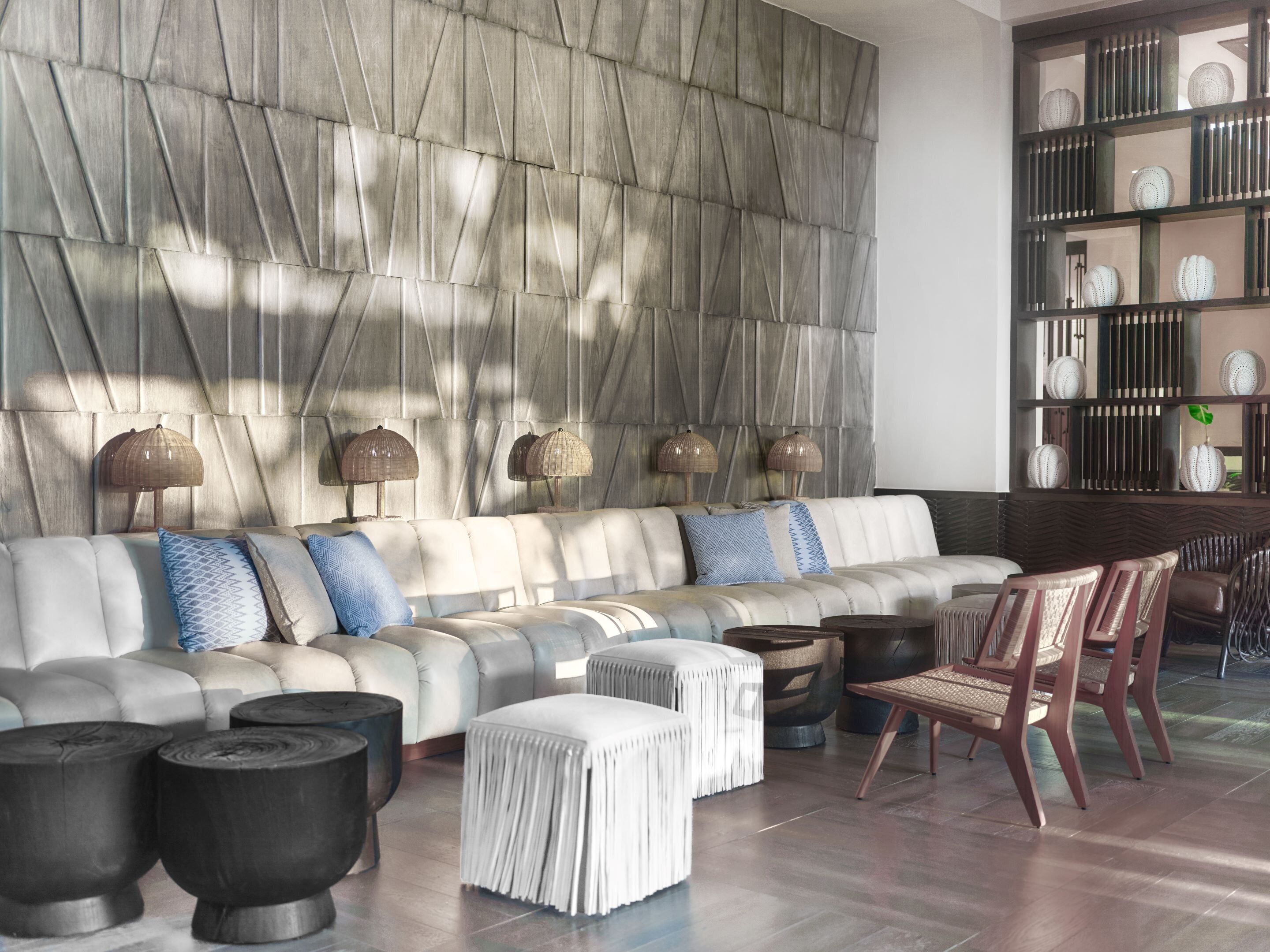 A modern living room with a sectional sofa, a coffee table, a side table, and a chair.