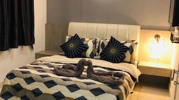 Desk, iron/ironing board, bed sheets