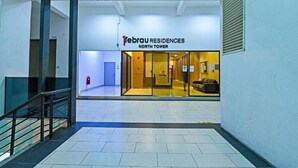 A modern building with a sign reading "1ebrau RESIDENCES NORTH TOWER". - 1 Tebrau Residences by YML Home (Johor Bahru)