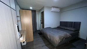 A bedroom with a bed, wardrobe, and an air conditioning unit. - W71  (Bangkok)