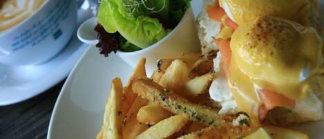 A plate with a sandwich, fries, and a salad.