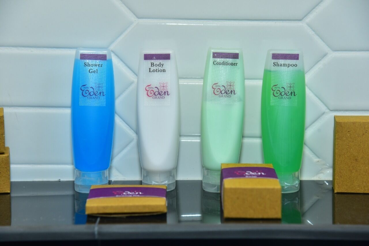 Quatre ampolles de productes de cura personal Eden Grand sobre una estant.
