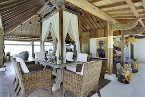 Traditional room with a dining area, seating area, and decorative wall featuring artwork.
