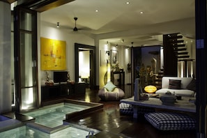 Relax in a stylish living area with a sofa, chair, and TV, offering a comfortable space to unwind.