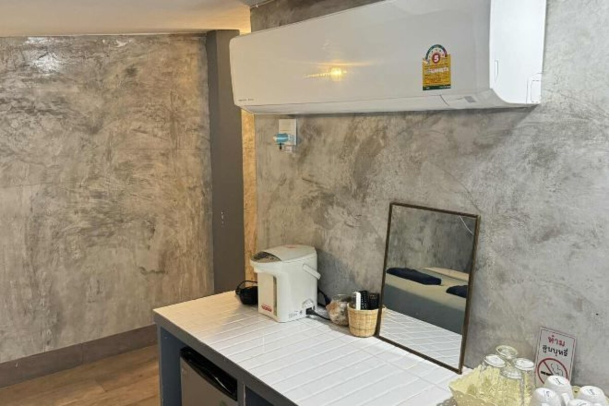 A bathroom with a countertop, a mirror, a towel rack, and a sign indicating no towel drying.
