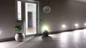 A hotel entrance with a potted plant, a door, and a wall-mounted sign. - "THE DREAM" among lemon groves and one of Italy's Most Beautiful Villages 5 minutes from the sea (ROCCA IMPERIALE)