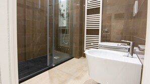 A modern bathroom with a glass shower enclosure, a white sink, and a towel rack. - "THE DREAM" among lemon groves and one of Italy's Most Beautiful Villages 5 minutes from the sea (ROCCA IMPERIALE)